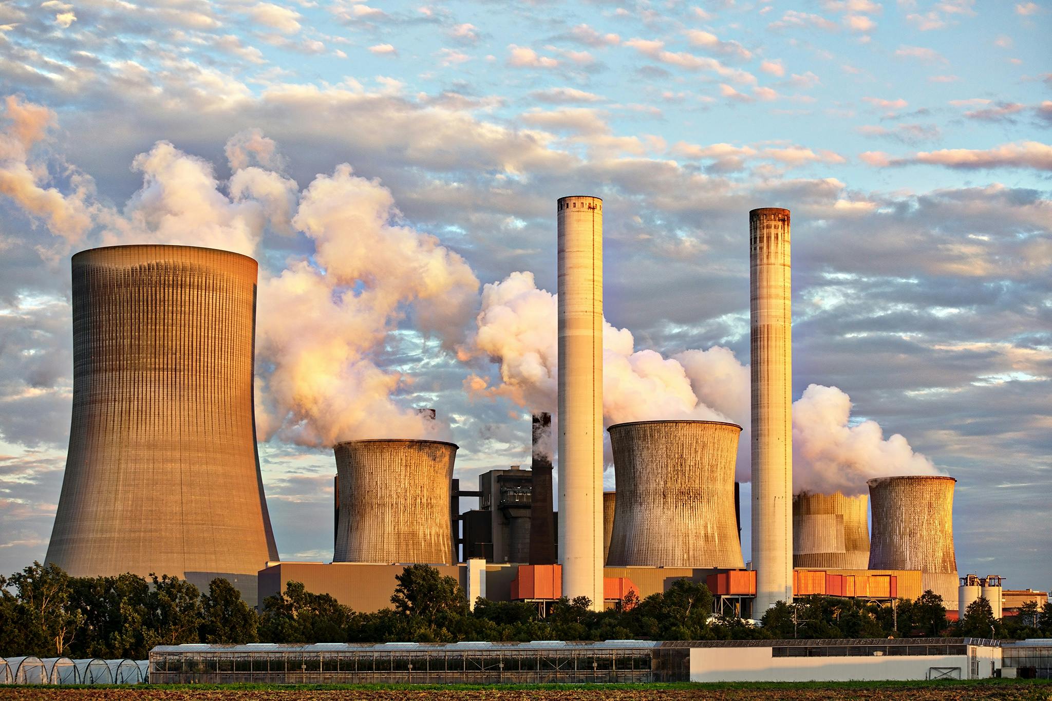 Traditional fossil fuel power plants emitting smoke